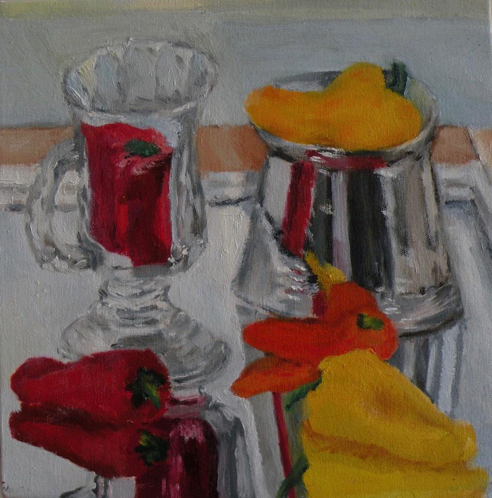 Several multicolored peppers and a glass mug on a mirror